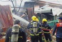 Firefighters spray water to this fire-hit portion of the public market in Laua-an, Antique. BFP-ANTIQUE