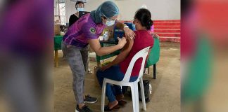 A healthcare worker administers a coronavirus disease 2019 vaccine to a resident of Concepcion, Iloilo. MAYOR RAUL BANIAS