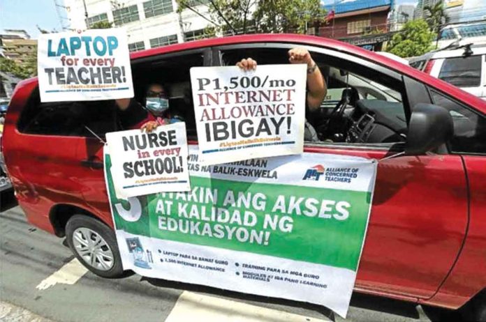 teachers JUST DEMANDS . Teachers hold a drive-by protest at the central office of the Department of Education in Pasig City. INQUIRER FILE PHOTO