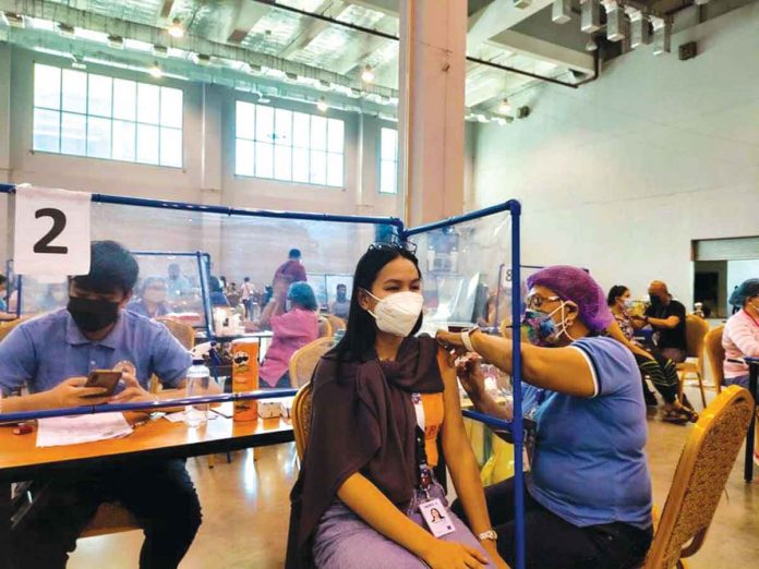 vax An eligible resident receives a Pfizer shot at the Iloilo Convention Center in Mandurriao, Iloilo City. PANAY NEWS PHOTO