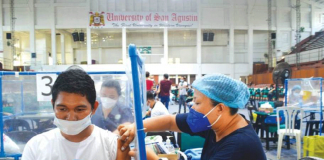 A healthcare worker receives the Pfizer vaccine against coronavirus disease 2019 (COVID-19) as a booster jab at the University of San Agustin in Iloilo City. Today marks the start of the nationwide inoculation drive. Western Visayas targets to vaccinate 1.2 million people in three days. PANAY NEWS PHOTO