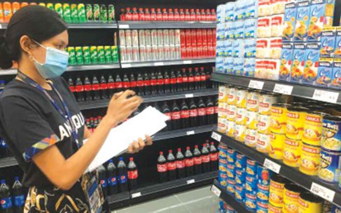 DTI An employee of the Department of Trade and Industry - Antique checks the prices of basic commodities at a retail store in San Jose de Buenavista town. Because the province is under a state of calamity, an automatic price ceiling is in effect based on November prices. PHOTO COURTESY OF DTI-ANTIQUE