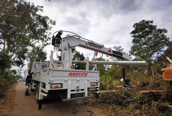 akelco A heavy equipment of Aklan Electric Cooperative is in Guimaras Island helping clear electric posts of typhoon debris. PHOTO BY GUIMELCO