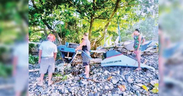 boat Fishermen of Libertad, Antique check their boats that the storm surge brought by super typhoon “Odette” destroyed. PHOTO FROM FACEBOOK PAGE OF MAYOR BEBOT NICOPIOR TE
