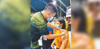 A resident of Bugasong, Antique gets vaccinated against coronavirus disease at the municipal gym. PHOTO FROM BUGASONG RHU