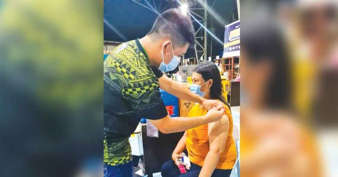 A resident of Bugasong, Antique gets vaccinated against coronavirus disease at the municipal gym. PHOTO FROM BUGASONG RHU