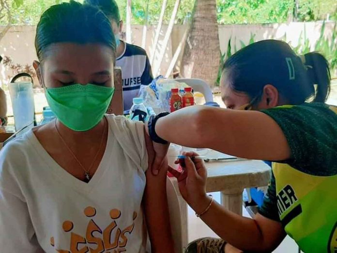 first-day A young woman gets a dose of the vaccine against coronavirus disease in Capiz.