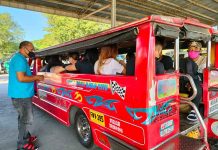 A jeepney driver collects fare from passengers at the transport terminal in Barangay Ungka, Jaro, Iloilo City. PANAY NEWS