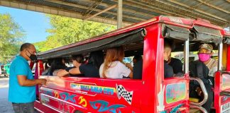 A jeepney driver collects fare from passengers at the transport terminal in Barangay Ungka, Jaro, Iloilo City. PANAY NEWS