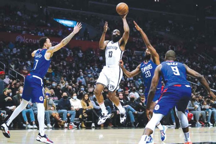 sports-brooklyn Brooklyn Nets’ James Harden shoots from between the defense of Los Angeles Clippers’ Amir Coffey and Justice Winslow. AP PHOTO