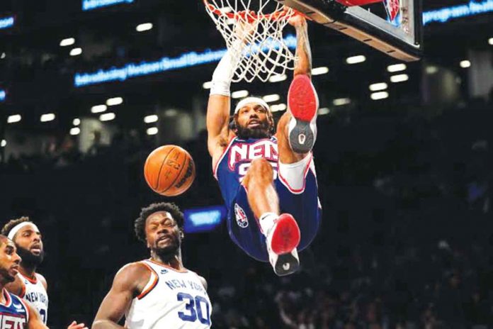 sports-brooklyn Brooklyn Nets guard DeAndre Bembry (95) dunks past New York Knicks forward Julius Randle (30) during the second half of an NBA basketball game on Nov. 30, 2021, in New York. AP PHOTO, MARY ALTAFFER