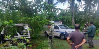 Policemen of Numancia, Aklan check this tricycle abandoned in Sitio Pigado, Barangay Bakhaw Sur, Kalibo, Aklan. It was used as a getaway vehicle of the men who stabbed to death its driver on Nov. 27, 2021.