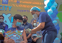 A youngster avails himself of an anti-coronavirus vaccine on the first day of the “Bayanihan Bakunahan” national vaccination drive at SM City Iloilo. PANAY NEWS PHOTO