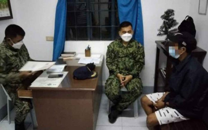 NPA Police Colonel Gilbert Gorero (center), director of the Iloilo Police Provincial Office (IPPO), talks to lias “Banban” / “Tatang” (right), a resident of Tubungan, Iloilo who surrendered to the police on Jan. 4, 2022.