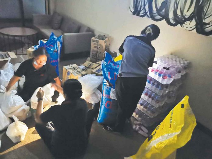 PMO-Photo-001 Property Management Offices team during the repacking of relief packs for affected residents and employees.