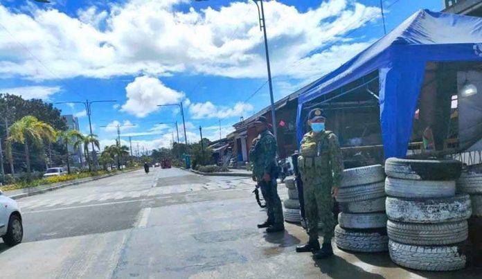 day1 Policemen man a checkpoint in Barangay Ungka, Jaro, Iloilo City. But the national highway is almost empty. Few people are going out. Many are heeding the advice of the city government not to go out unless the trip is essential, due to the rising cases of coronavirus disease 2019. RUBY SILUBRICO