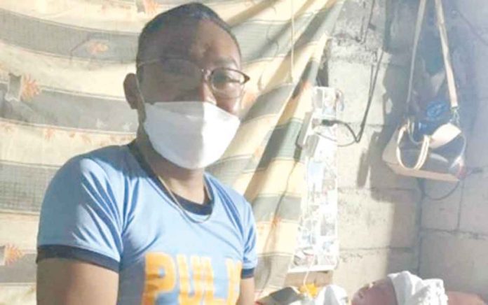 policeman Patrolman Lhar Talaga of the Caticlan Airport Police Station in Malay, Aklan helped a woman who was giving birth in Barangay Afga, Tangalan, Aklan on Jan. 27, 2022. Philippine National Police chief, General Dionardo Carlos, lauded Talaga for his deed beyond the call of duty. PHOTO COURTESY OF PNP PIO