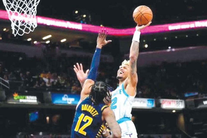 sports-charlotte Charlotte Hornets’ Kelly Oubre Jr. soars for a basket while being defended by Indiana Pacers’ Oshae Brissett. AP PHOTO