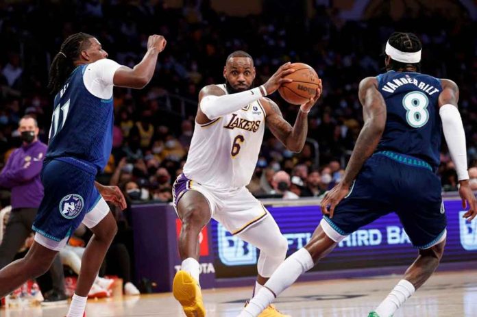 sports-lakers-pic Los Angeles Lakers forward LeBron James (6) drives between Minnesota Timberwolves center Naz Reid (11) and Jarred Vanderbilt (8). PHOTO BY RINGO H.W. CHIU/AP