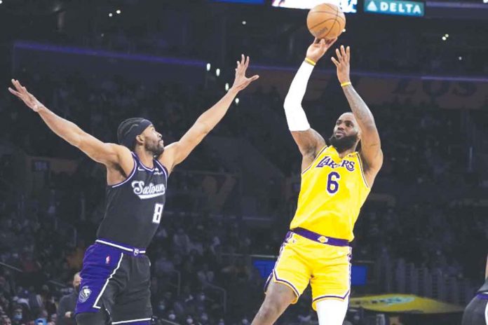 sports-lebron Los Angeles Lakers forward LeBron James (6) shoots over Sacramento Kings forward Maurice Harkless (8). Photo by Marcio Jose Sanchez / Associated Press