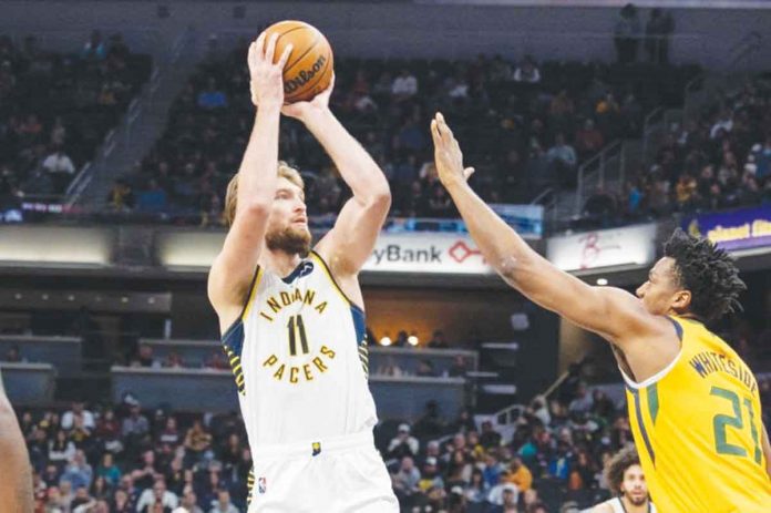 sports-sabonis Indiana Pacers’ Domantas Sabonis shoots the ball while being defended by Utah Jazz’s Hassan Whiteside. USA TODAY PHOTO