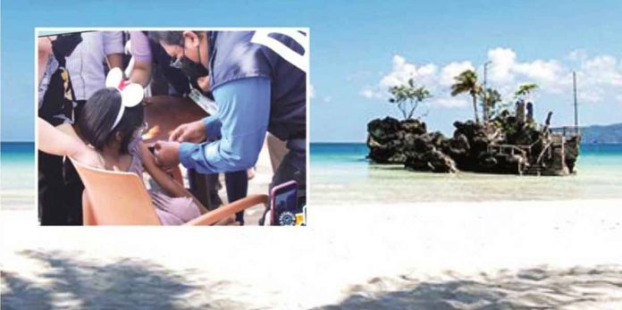 Boracay Island has long prepared to welcome foreign tourists back. Photo shows the island’s most photographed feature – Willy’s Rock. Inset photo shows a young girl in Boracay receiving a shot of COVID-19 vaccine from Regional Director Adriano Suba-an of the Department of Health Region 6. Pediatric vaccination against the viral disease was launched in the island on Friday. PHOTO BY MALAY MUNICIPAL TOURISM OFFICE