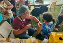 BRAVE GIRL. A young girl stays still while being vaccinated against coronavirus disease 2019 at SMs City Iloilo in Mandurriao district. PH PHOTO
