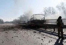 A damaged vehicle is seen at the site of a fighting with Russian raiding troops after Russia launched a massive military operation against Ukraine, in Kyiv, Ukraine February 26, 2022. REUTERS