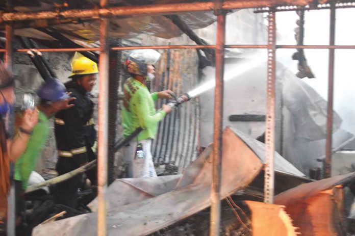 FIRE ALERT. Firefighters spray with water these houses that fire gutted in Barangay Old Airport, Mandurriao, Iloilo City late afternoon to early evening on March 11, 2022. Sixty-six houses were destroyed and 107 families were displaced. They temporarily sought shelter at the Mandurriao Elementary School. PN PHOTOS FIRE ALERT. Firefighters spray with water these houses that fire gutted in Barangay Old Airport, Mandurriao, Iloilo City late afternoon to early evening on March 11, 2022. Sixty-six houses were destroyed and 107 families were displaced. They temporarily sought shelter at the Mandurriao Elementary School. PN PHOTOS