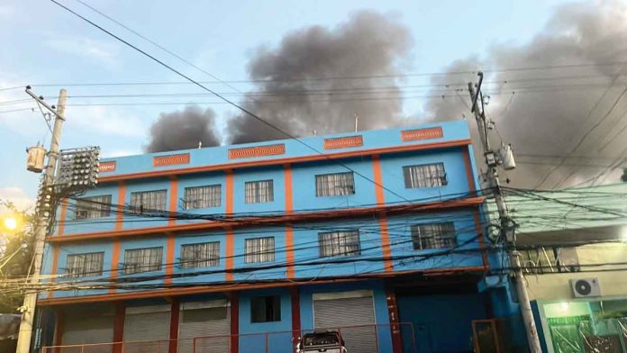 Dark smoke billows from the back of this building in Iloilo City. Data from the City Disaster Risk Reduction and Management Office showed 35 houses were damaged. PANAY EMERGENCY PHOTO