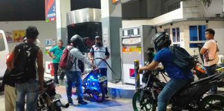 Motorcycle riders wait for their turn to refuel at a gas station in Pavia, Iloilo on Friday night, hours before another round of fuel price increase takes effect. PN PHOTO
