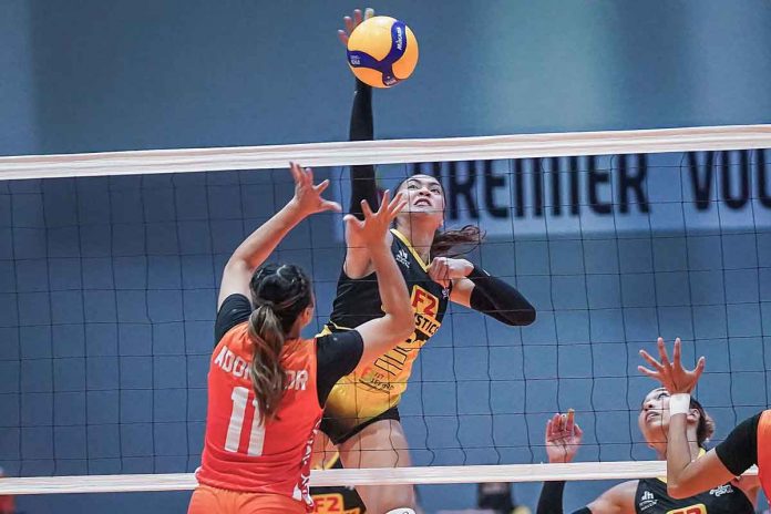 sports-F2-pic Abigail Maraño of F2 Logistics Cargo Movers drops the ball against the defense of fellow Ilongga Ma. Shaya Adorador of Chery Tiggo Crossovers. PVL MEDIA BUREAU