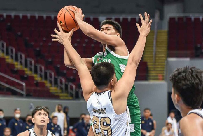 sports-negrense-pic Negrense Mark Nonoy of De La Salle University Green Archers attacks the defense of National University Bulldogs center Germy Mahinay. UAAP MEDIA BUREAU