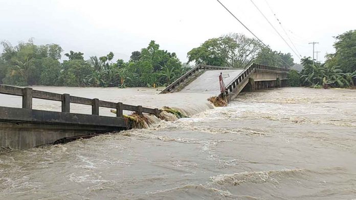 BRIDGE OVER TROUBLED WATERS. Residents of Dingle, Iloilo can’t cross to the other side of this river. The bridge straddling the river has collapsed due to the strong water current. The river swelled because of the heavy rains unleashed by Tropical Depression “Agaton” from April 10 to 12, 2022. PN PHOTO