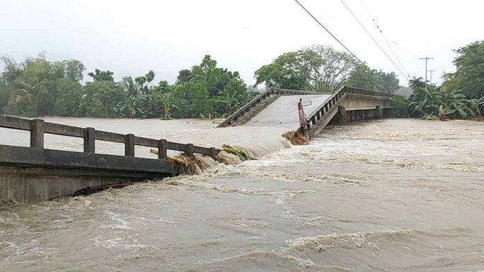 bridge2 BRIDGE OVER TROUBLED WATERS. Residents of Dingle, Iloilo can’t cross to the other side of this river. The bridge straddling the river has collapsed due to the strong water current. The river swelled because of the heavy rains unleashed by Tropical Depression “Agaton” from April 10 to 12, 2022. PN PHOTO