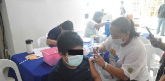 A youngster gets his dose of the vaccine against coronavirus disease 2019 at the Iloilo provincial capitol. Fearing a possible surge in infections after the elections, the provincial government is stepping up its vaccination drive. PN PHOTO