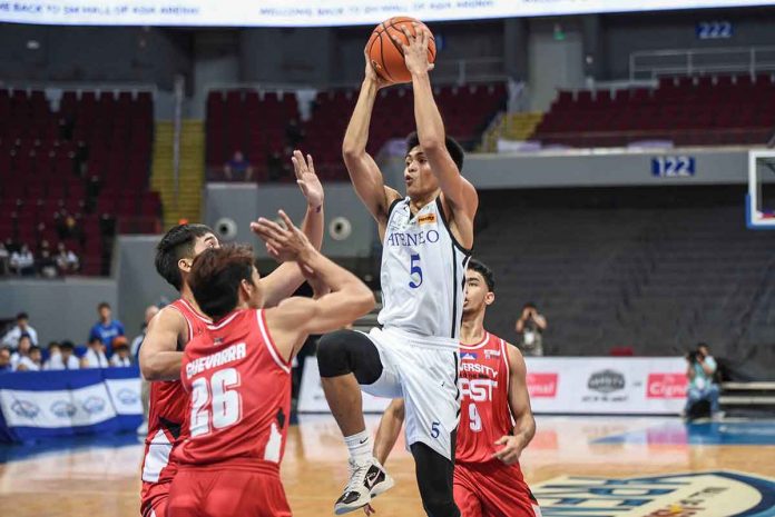 sports-mamuyac-pic Ateneo de Manila University Blue Eagles’ Gian Mamuyac attacks the University of the East Red Warriors defenders for an inside hit. UAAP MEDIA BUREAU
