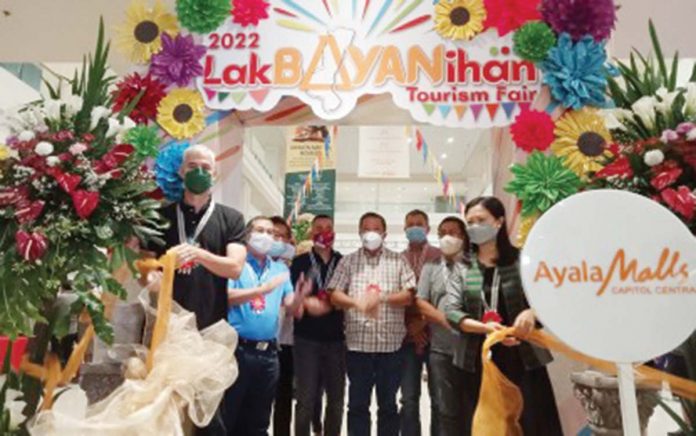 biz1 Negros Occidental’s Gov. Eugenio Jose Lacson (left) and Department of Tourism – Western Visayas director Cristine Mansinares (right) lead the opening of the Lakbayanihan Tourism Fair 2022 in Bacolod City on May 16. The province’s first tourism fair in two years, the event, which runs until May 29, promotes tourism attractions across the province's 32 city and municipal governments, including the capital city of Bacolod, in a bid to revive the local tourism industry. PNA PHOTO BY NANETTE GUADALQUIVER