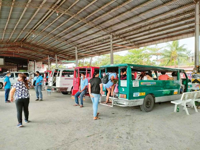 front-pic At the transport terminal in Barangay Ungka, Jaro, Iloilo City, drivers wait for their traditional jeepneys to be filled with passengers before leaving. PN PHOTO