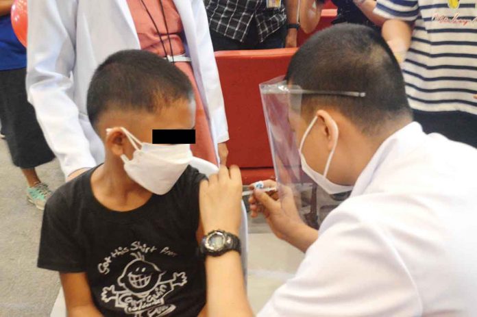 front-pic A healthcare worker of the Iloilo provincial government vaccines a boy against coronavirus disease 2019. Frontline healthcare workers are being urged to get second COVID-19 vaccine booster shots for better protection against the disease, and particularly against new variants and subvariants of the virus causing it. PN PHOTO