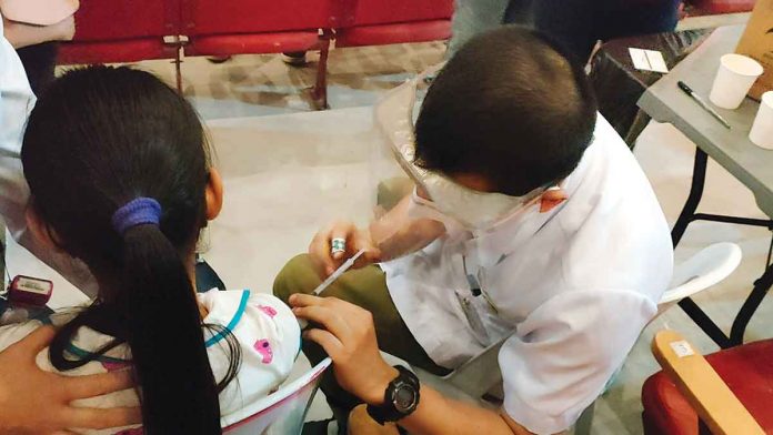 front-pic A young girl receives her shot of the vaccine against coronavirus disease 2019. COVID-19 vaccines are safe, according to the Department of Health. They have been given Emergency Use Authorization by the Food and Drug Administration. PN PHOTO