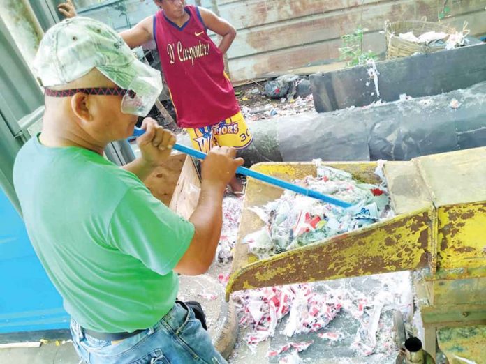 front-pic1 Torn campaign posters gathered across Iloilo City are being fed and re-fed to this shredder machine in Barangay Calajunan, Mandurriao district – where the city’s sanitary landfill is located – to come up with finely-textured shredded materials for recycling as alternative fuel for a cement factory. PHOTO BY ENGR. NEIL RAVENA/CENRO
