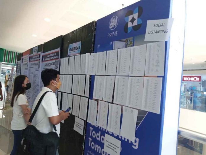 news-underemployment-pic Job hunters check lists of vacancies during the Labor Day jobs fair on May 1 at a mall in Mandurriao, Iloilo City. The Department of Trade and Industry underscores to job hunters and even to those already employed the importance of “upskilling”. This will open better job opportunities. PHOTO BY GLENDA SOLOGASTOA/PN