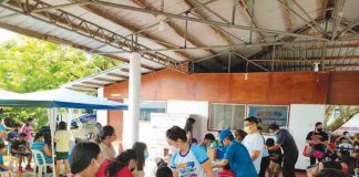People gather at a vaccination site against coronavirus disease in Aklan.