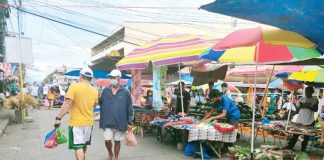 In Aklan, 79.53 percent of its eligible population is already fully vaccinated against coronavirus disease, according to the Department of Health. Photo shows market shoppers and vendors wearing facemask in Kalibo, Aklan.