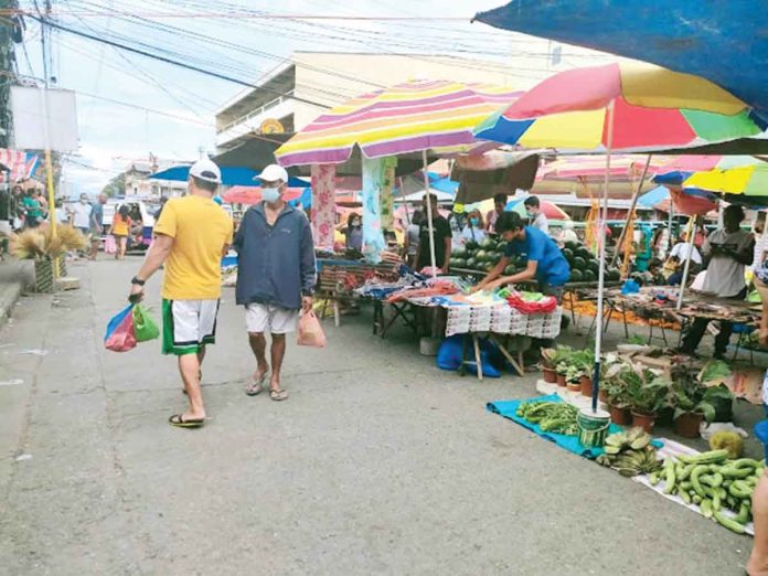 region-aklan-low In Aklan, 79.53 percent of its eligible population is already fully vaccinated against coronavirus disease, according to the Department of Health. Photo shows market shoppers and vendors wearing facemask in Kalibo, Aklan.