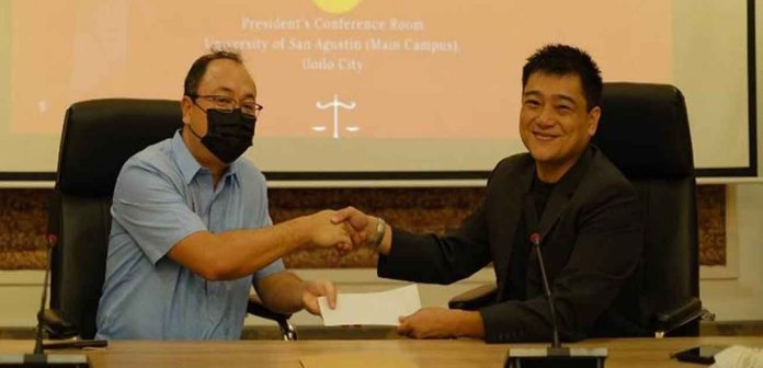san-ag2 University President Fr. Frederick C. Comedador, OSA accepts the donation from Atty. Jan Freeman Villegas.