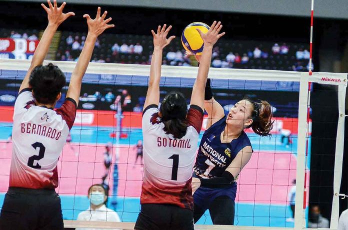 Princess Ann Robles of the National University Lady Bulldogs slams the ball against the defense of fellow Ilongga Marianne Sotomil of the University of the Philippines Fighting Maroons. UAAP MEDIA BUREAU