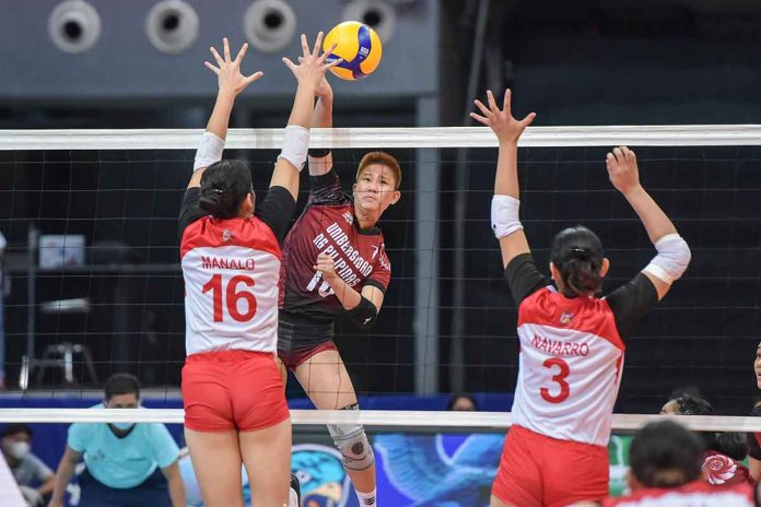 sports-bertolano-pic-and-caption Negrense Alyssa Bertolano of the University of the Philippines Fighting Maroons attempts an attack against two University of the East Lady Red Warriors defenders. UAAP MEDIA BUREAU