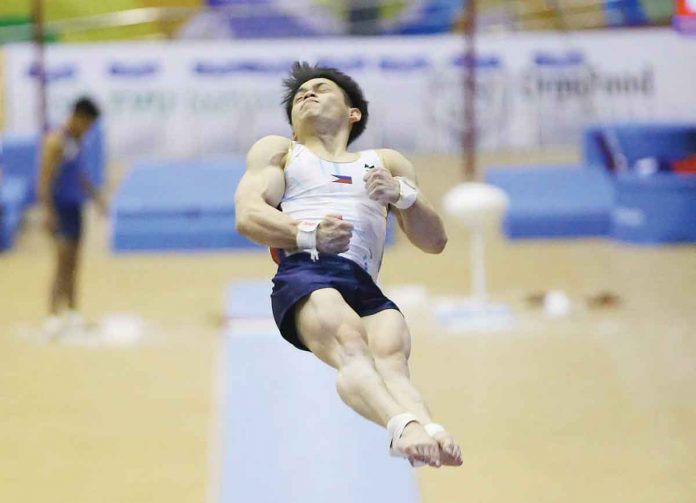 sports-high Filipino gymnast Carlos Edriel Yulo is in midair during the vault event of the 31st Southeast Asian Games on Monday. PSC MEDIA PHOTO